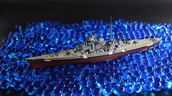 warship, ship model, blue, selective focus, indoors, no people, illuminated, night, teamwork, cooperation, light - natural phenomenon, seat, performance, technology, stadium, lighting equipment, close-up, event, luxury, entertainment event, stage, 4K, CC0, public domain, royalty free