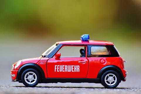 red die-cast car, fire, mini cooper, auto, model car, red, blue light, vehicle, toys, toy car, mode of transportation, transportation, car, motor vehicle, retro styled, land vehicle, toy, no people, fun, travel, copy space, safety, studio shot, day, text, small, 4K, CC0, public domain, royalty free