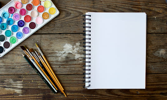 white, sketch pad, coloring supplies, brown, wooden, desk, spiral, book, surface, still, items, things, paint, watercolor, brushes, pencil, sketch, pad, table, art, craft, hobby, illustrate, design, wood - material, directly above, paintbrush, indoors, palette, large group of objects, choice, note pad, color swatch, spiral notebook, no people, high angle view, creativity, education, writing instrument, pen, multi colored, copy space, brush, still life, art and craft, paper, art and craft equipment, blank, watercolor paints, 5K