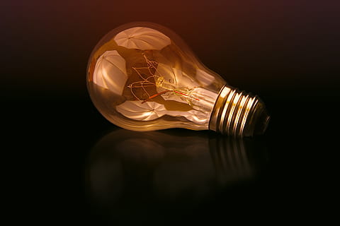 incandescent, bulb, black, surface, bulb light, photo, reflection, lightbulb, light, glass, light Bulb, electric Lamp, lighting Equipment, illuminated, glowing, electricity, creativity, technology, ideas, energy, innovation, light - Natural Phenomenon, inspiration, power, shiny, glass - Material, filament, imagination, bright, single Object, wealth, luxury, studio shot, indoors, copy space, close-up, no people, black background, transparent, success, electric light, finance, 5K