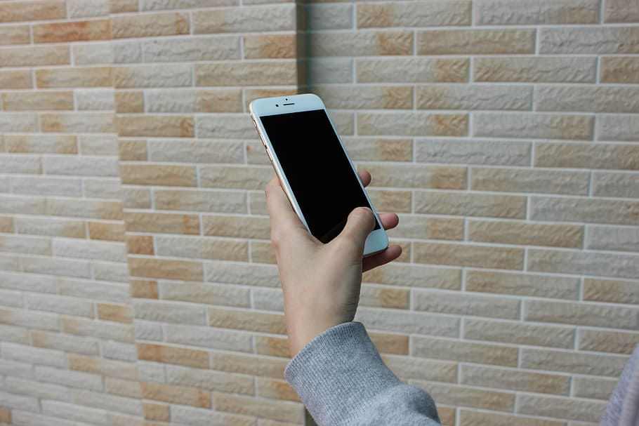 iphone, 6, 6s, mà, telèfon, noia, poma, paret, ios, bresca, dades, tecnologia, comunicació, mà humana, una persona, tecnologia sense fils, connexió, telèfon intel·ligent, persones reals, part del cos humà, paret de maó, maó, celebració, funció de construcció de parets, dispositiu d’informació portàtil, estils de vida, telèfon mòbil, activitat d'oci, pantalla, a l'aire lliure, dit, 5K