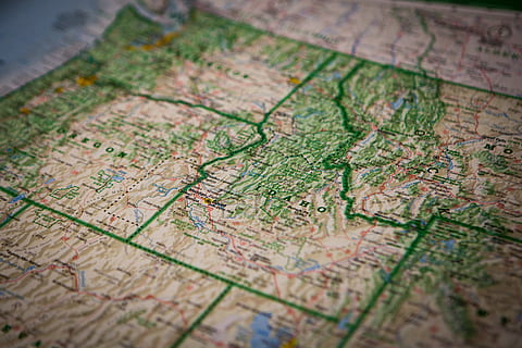 world map close-up photo, map, closeup, photography, still, items, things, maps, topography, directions, high angle view, close-up, no people, day, indoors, selective focus, direction, travel, guidance, text, full frame, backgrounds, exploration, communication, western script, holiday, world map, extreme close-up, wood - material, 2K