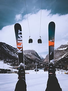 person, sitting, snow, wearing, snow skis, green-and-orange snow skis, ski, skilift, mountain, clouds, skier, winter, cold temperature, sky, nature, cloud - sky, beauty in nature, transportation, real people, leisure activity, flag, day, mountain range, scenics - nature, cable car, lifestyles, sport, environment, outdoors, snowcapped mountain, 4K, CC0, public domain, royalty free