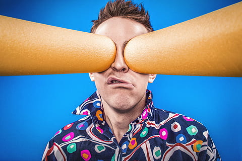 closeup, photography, man, wearing, black, green, orange, multicolored, collared, top, two, cylindrical, brown, stick, poking, eyes, closeup photography, people, whimsical, lazy, crazy, blue, portrait, special, pattern, funny, silly, strange, weird, humor, glasses, men, one Person, males, adult, caucasian Ethnicity, young Adult, young Men, outdoors, adults only, headshot, one man only, human body part, body part, close-up, multi colored, emotion, front view, sky, nature, fun, human limb, human face, human arm, 5K
