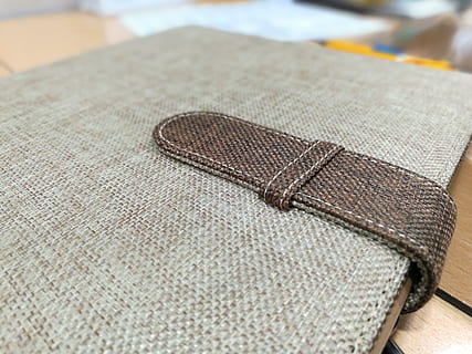 folder, burlap, ecological, textile, indoors, close-up, still life, no people, table, focus on foreground, selective focus, textured, pattern, craft, art and craft, brown, thread, clothing, towel, fashion, creativity, day, man made, personal accessory, leather, 2K, CC0, public domain, royalty free