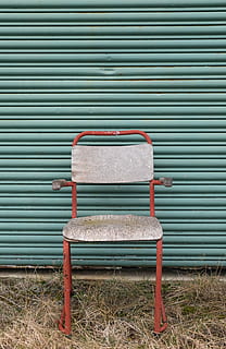 armchair, front, roller shutter, red, gray, padded, beside, green, roll, door, chair, old, wall, background, aesthetic, grass, retro styled, old-fashioned, corrugated iron, weathered, rusty, no people, outdoors, day, seat, absence, empty, metal, iron, shutter, pattern, architecture, wall - building feature, bench, built structure, wood - material, park bench, wheel, 4K