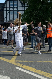torch, fire, flame, runner, olympic games, london, sport, sports, athletes, athlete, athletics, olympic torch, people, wrestling, medals, victories, placement, evaluation, power, symbol, city, group of people, architecture, street, crowd, real people, building exterior, men, full length, walking, large group of people, road, casual clothing, road marking, day, lifestyles, women, built structure, adult, motion, outdoors, 1080P, CC0, public domain, royalty free