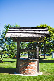 architecture, bricks, deep well, grass, lawn, trees, outdoors, wood - Material, plant, built structure, nature, sky, building exterior, sunlight, day, roof, tree, house, building, no people, green color, growth, blue, clear sky, shadow, 5K, CC0, public domain, royalty free