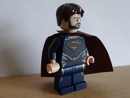 superman mini figure toy, superman, held, action hero, power, fantasy world, savior, indoors, table, human representation, representation, art and craft, wall - building feature, figurine, wood - material, retro styled, no people, male likeness, technology, still life, antique, robot, futuristic, female likeness, toy, 2K, CC0, public domain, royalty free