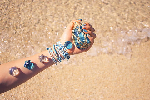 person, holding, translucent, blue, glass bottle, assorted, accessories, arm, blue glass, beach, sand, summer, sea, people, outdoors, one woman only, only women, adults only, one person, adult, human body part, land, hand, human hand, day, bracelet, focus on foreground, nature, sunlight, women, lifestyles, real people, body part, close-up, finger, personal accessory, human limb, 1080P, CC0, public domain, royalty free