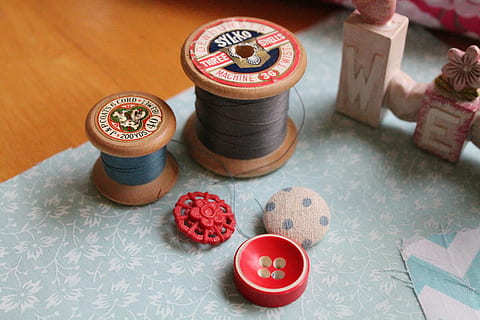 two, gray, blue, thread spools, thread, buttons, sewing, textile, needle, fabric, needlework, sew, spool, vintage thread, no people, indoors, high angle view, still life, table, variation, focus on foreground, art and craft, craft, choice, large group of objects, group of objects, multi colored, close-up, studio shot, arrangement, pattern, ornate, 4K, CC0, public domain, royalty free