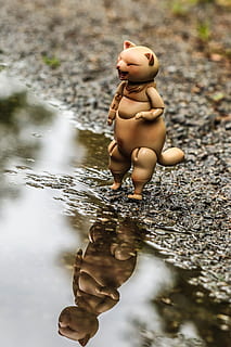 toy, puddle, water, reflection, representation, human representation, full length, childhood, art and craft, nature, figurine, focus on foreground, day, male likeness, people, selective focus, outdoors, high angle view, 5K, CC0, public domain, royalty free