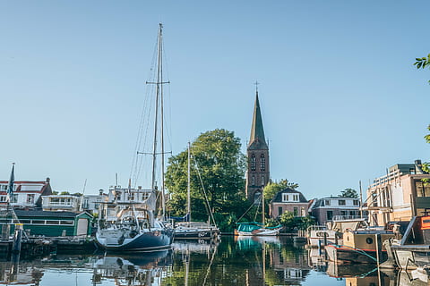 boats parking, port, white, sailboat, body, water, towns, village, city, docks, boats, yachts, marina, lake, reflection, trees, sky, nautical vessel, moored, harbor, building exterior, travel destinations, architecture, built structure, mode of transportation, transportation, building, clear sky, nature, mast, religion, day, place of worship, no people, canal, outdoors, spire, 2K