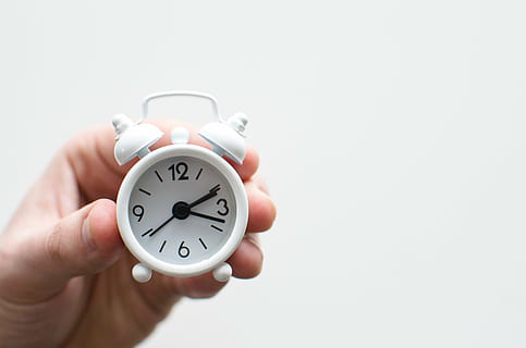 person, holding, white, analog desk clock, tiny, alarm, clock, time, hand, alarm Clock, human Hand, morning, copy space, clock face, human body part, single object, minute hand, number, studio shot, deadline, indoors, white background, close-up, second hand, cut out, checking the time, finger, chrome, countdown, 5K