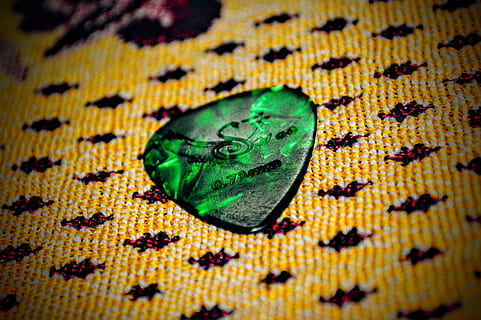 guitar pick, plectrum, green, triangular, accessory, guitar, hobby, close-up, textile, indoors, green color, no people, high angle view, full frame, yellow, food, emotion, backgrounds, food and drink, selective focus, sweet food, wealth, jewelry, shiny, dessert, pattern, multi colored, luxury, 4K, CC0, public domain, royalty free