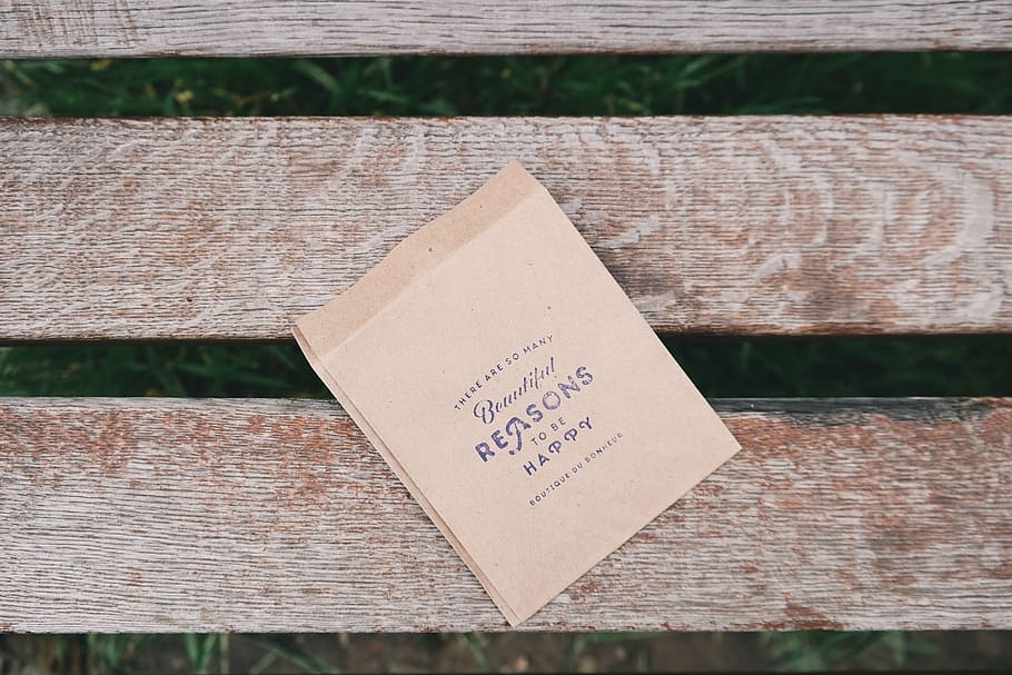 brown, paper, wood plank, reasons, happy, bag, bench, park, text, western script, communication, mail, day, outdoors, no people, envelope, close-up, wood - material, high angle view, information, plank, focus on foreground, non-western script, script, table, nature, positive emotion, still life, message, 5K