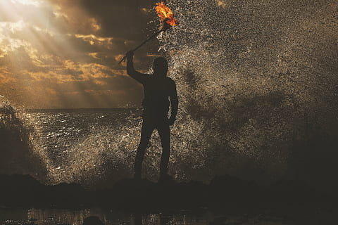 silhouette of man, fire, dance, people, beach, sand, dark, night, happy, shadow, silhouette, splash, water, real people, one person, standing, full length, outdoors, lifestyles, sunset, men, sea, nature, sky, leisure activity, splashing, beauty in nature, human arm, motion, arms raised, 5K, CC0, public domain, royalty free