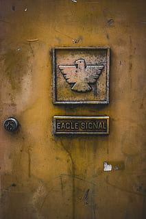 Adler-Signal-Emblem, Adler-Signal-Logo, Zeichen, Tür, sperren, Adler, Signal, Text, Kommunikation, westliche Schrift, keine Leute, Wandbau - Funktion, alt, die Architektur, gebaute Struktur, Nahansicht, Großbuchstabe, Metall, Tag, Kunst und Handwerk, Gelb, verwittert, drinnen, Darstellung, Wand, Kreativität, 5K, CC0, gemeinfrei, lizenzfrei