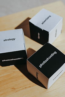 little, paper boxes, words, paper, boxes, table, box, strategy, cardboard, photoshooting, advertising, business, identity, text, indoors, passport, no people, close-up, western script, still life, communication, selective focus, high angle view, capital letter, document, focus on foreground, publication, wood - material, black color, book, education, two objects, 2K, CC0, public domain, royalty free