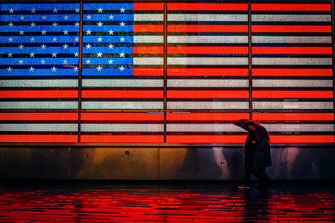 American flag, architecture, background, building, color, dark, design, expression, flag, graphic, light, line, outdoors, pattern, people, texture, umbrella, one person, walking, full length, city, real people, standing, red, striped, built structure, building exterior, wall - building feature, multi colored, travel, lifestyles, motion, rain, 4K, CC0, public domain, royalty free