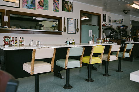 assorted-color barstools, front, table, bar stools, beside, indoors, food and drink, seat, chair, business, no people, cafe, bar - drink establishment, shelf, furniture, bottle, container, absence, bar counter, lifestyles, restaurant, day, arrangement, architecture, 5K, CC0, public domain, royalty free