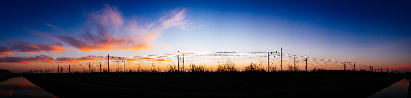 silhouette, street post light, grass, white, cloud, blue, sky, daytime, dawn, dusk, field, outdoors, panoramic, power lines, sunrise, sunset, wire, cloud - sky, nature, landscape, no people, industry, fuel and power generation, environment, scenics - nature, pollution, technology, factory, smoke - physical structure, horizon over land, 8K, CC0, public domain, royalty free