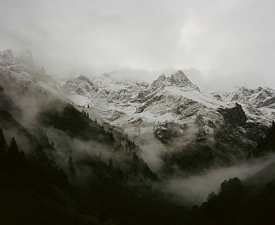 snow covered mounatins, snow, capped, mountains, surrounded, fog, mountain, cloud, mist, tree, forest, hiking, hike, travel, rock, autumn, alpen, alp, moody, scenics - nature, beauty in nature, tranquil scene, environment, tranquility, non-urban scene, landscape, cold temperature, sky, winter, mountain range, cloud - sky, no people, nature, idyllic, day, remote, outdoors, snowcapped mountain, hazy, mountain peak, 1080P, CC0, public domain, royalty free