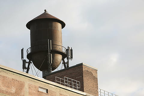 low-angle photography, gray, rain water tank, top, building, nimbus clouds, water, tank, sky, water tower, rooftop, bricks, wall, building exterior, low angle view, built structure, architecture, day, outdoors, no people, industry, nature, factory, storage tank, cloud - sky, metal, copy space, communication, water tower - storage tank, window, tower, 5K, CC0, public domain, royalty free