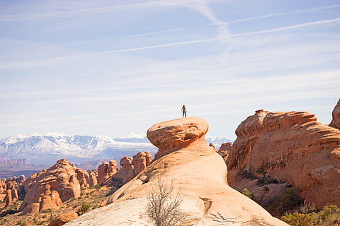 person, top, canyon, photo, standing, rock, Arches, NP, nature, desert, landscape, rock - Object, scenics, uSA, outdoors, utah, sky, extreme Terrain, sandstone, red, beauty In Nature, rock Formation, national Park, eroded, mountain, geology, wilderness Area, southwest USA, day, no people, one animal, animals in the wild, scenics - nature, solid, non-urban scene, tranquil scene, mountain range, leisure activity, tranquility, travel destinations, physical geography, cloud - sky, real people, environment, formation, climate, arid climate, 5K, CC0, public domain, royalty free