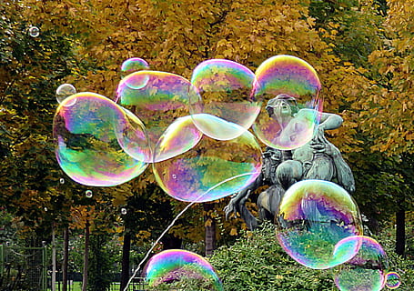 bubbles, gray, concrete, fountain, trees, daytime, statue, color, rainbow, bubble, multi colored, fragility, vulnerability, nature, mid-air, day, soap sud, transparent, outdoors, plant, bubble wand, no people, beauty in nature, tree, shiny, fun, reflection, flying, lightweight, 1080P, CC0, public domain, royalty free