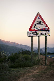 road signage, asphalt road, km, h, signage, full, stickers, road, signs, yield, deer, speed limit, mountains, sky, text, outdoors, no people, mountain, communication, landscape, sunset, travel destinations, grass, road sign, sign, western script, plant, nature, guidance, beauty in nature, environment, land, scenics - nature, information, tranquility, field, tranquil scene, 1080P
