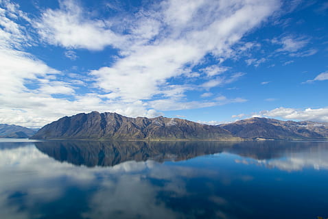 mountain, reflecting, calm, lake, photo, brown, reflection, clear, body, water, blue, sky, clouds, landscape, nature, scenics, beauty in nature, tranquility, waterfront, tranquil scene, scenics - nature, cloud - sky, mountain range, day, no people, environment, non-urban scene, idyllic, remote, outdoors, purity, 5K, CC0, public domain, royalty free