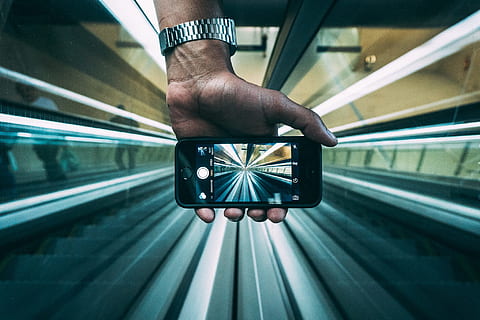 person, holding, iphone, taking, empty, walkalator, escalators, hand, macro, mobile phone, perspective, smartphone, tube, transportation, mode of transportation, rail transportation, one person, travel, indoors, human body part, men, train - vehicle, railroad station, adult, public transportation, train, journey, architecture, direction, station, subway train, track, 1080P, CC0, public domain, royalty free