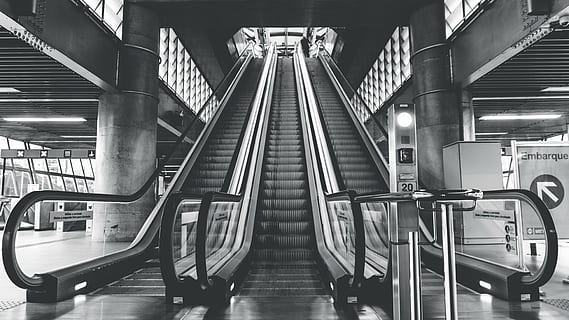 grayscale photo, escalators, architecture, building, infrastructure, structure, establishment, escalator, stairs, station, black and white, monochrome, transportation, subway train, subway station, indoors, mode of transport, staircase, industry, modern, illuminated, railing, convenience, technology, rail transportation, public transportation, built structure, mode of transportation, steps and staircases, connection, metal, absence, no people, moving walkway, ceiling, 5K, CC0, public domain, royalty free