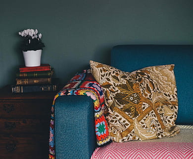 yellow, throw, pillow, blue, couch, beside, pile, books, top, drawer, brown, orange, teal velvet sofa, cushion, sofa, settee, decor, interior, plant, pot, blanket, indoors, no people, home interior, furniture, flower, table, still life, close-up, flowering plant, textile, wall - building feature, pattern, publication, book, clothing, seat, art and craft, chair, floral pattern, 2K, CC0, public domain, royalty free