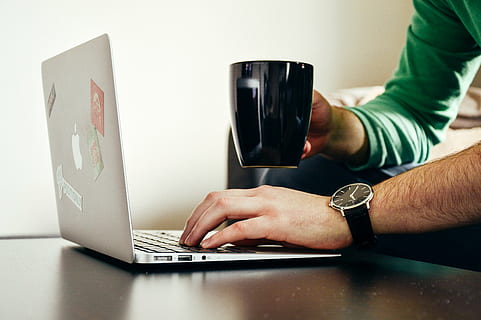apple, computer, laptop, macbook, man, mug, person, wristwatch, men, human Hand, technology, internet, working, people, human body part, one person, wireless technology, indoors, adult, communication, hand, connection, body part, table, limb, human limb, furniture, using laptop, human arm, 5K