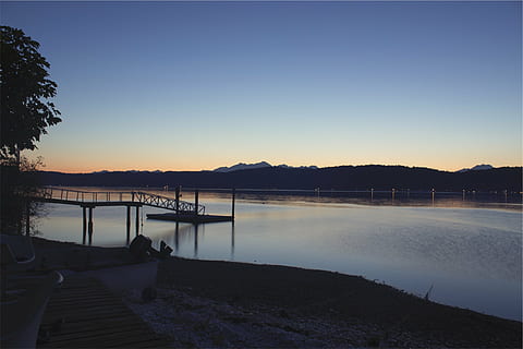 silhouette dock, silhouette, dusk, photo, boat, dock, river, blue, calm, sky, sunset, lake, water, scenics, tranquility, tranquil scene, beauty in nature, nature, scenics - nature, mountain, no people, transportation, nautical vessel, clear sky, non-urban scene, mountain range, reflection, outdoors, 1080P, CC0, public domain, royalty free
