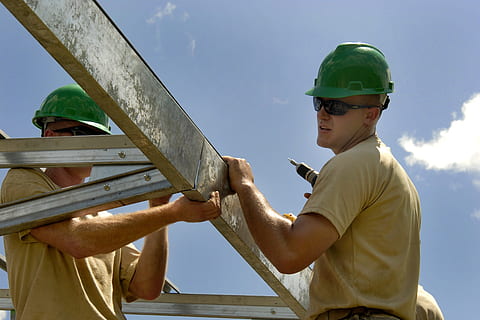 man, wearing, beige, shirt, green, safety helmet, holding, white, steel bars, construction, worker, building, installing, fascia, site, industry, hardhat, labor, male, builder, construction Industry, men, construction Worker, manual Worker, outdoors, people, construction Site, real people, sky, casual clothing, helmet, waist up, occupation, hat, young adult, low angle view, young men, males, working, lifestyles, nature, mature men, 4K