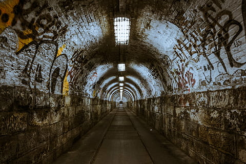gray, brown, concrete, tunnel, underground, underpass, lighting, budapest, dark, spooky, dirty, architecture, corridor, old, horror, direction, the way forward, diminishing perspective, indoors, no people, arch, built structure, empty, wall - building feature, abandoned, graffiti, footpath, vanishing point, illuminated, lighting equipment, history, light at the end of the tunnel, 5K
