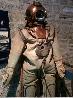 diving, diver, costume, museum, helmet, equipment, load, old model, representation, human representation, security, protection, three quarter length, wall - building feature, front view, people, male likeness, metal, safety, technology, clothing, standing, art and craft, gas mask, work helmet, architecture, government, suit of armor, 2K, CC0, public domain, royalty free