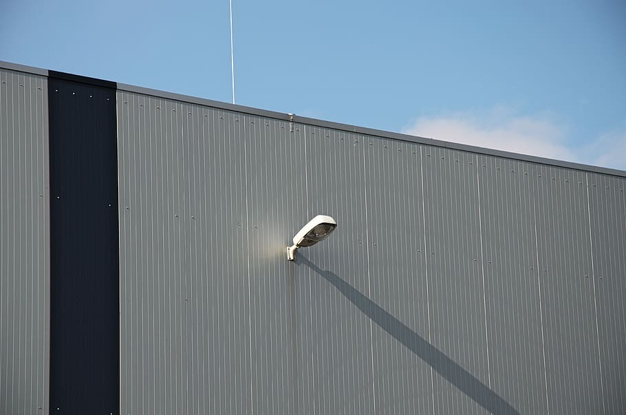 væg, facade, struktur, mønster, belysning, lampe, skygge, blå, grå, tag, dag, udendørs, ingen mennesker, bygning udvendig, bølgebryder, overvågningskamera, arkitektur, bygget struktur, murbygningsfunktion, overvågning, sikkerhed, lav vinkel visning, himmel, sikkerhedssystem, beskyttelse, teknologi, metal, sollys, industri, natur, bølgepap, storebror - orwellske koncept, 4K