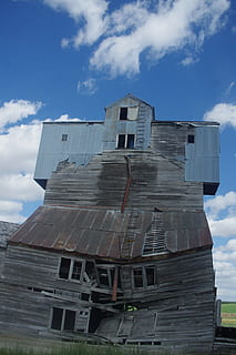 grain, elevator, decrepit, farm, storage, granary, warehouse, country, silo, agriculture, wheat, sky, cloud - sky, architecture, built structure, building exterior, low angle view, nature, day, no people, building, outdoors, industry, residential district, window, obsolete, metal, factory, old, communication, sunlight, 2K, CC0, public domain, royalty free