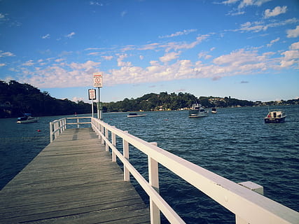 architecture, beach, boats, clouds, dock, harbor, island, landscape, ocean, outdoors, pier, sailboat, sea, seashore, ship, sky, summer, tourism, transportation system, travel, vacation, water, watercraft, wooden floor, yacht, built structure, cloud - sky, nature, beauty in nature, building exterior, day, direction, scenics - nature, no people, tranquil scene, tranquility, railing, land, 2K, CC0, public domain, royalty free