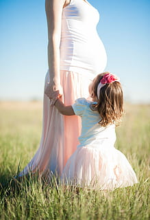 girl, white, pink, puff sleeve dress, pregnant, mother, standing, green, grass, daytime, girl in white, puff sleeve, dress, green grass, outdoors, women, people, nature, summer, females, caucasian Ethnicity, meadow, field, happiness, lifestyles, beauty, adult, child, young Adult, parent, sky, beautiful, family, smiling, sunlight, cheerful, lifestyle, green Color, love, girls, two people, togetherness, real people, land, plant, leisure activity, day, one person, sitting, clothing, hairstyle, 5K
