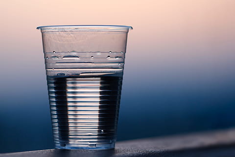 clear, plastic cup, gray, surface, closeup, cup, drink, drinking water, plastic, water, royalty  images, glass, drinking glass, household equipment, indoors, no people, food and drink, transparent, refreshment, still life, close-up, glass - material, studio shot, table, focus on foreground, colored background, single object, purity, 4K, CC0, public domain, royalty free