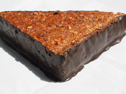 walnut corner, pastry, sweetness, triangular, chocolate, nibble, baked goods, fine pastry, viennoiseries, sweet, calories, food, food and drink, indoors, sweet food, freshness, still life, close-up, ready-to-eat, dessert, studio shot, white background, baked, no people, high angle view, indulgence, unhealthy eating, brown, temptation, focus on foreground, snack, melting, 4K, CC0, public domain, royalty free
