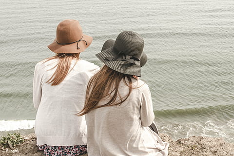 brown, black, hats, photo, two, woman, sitting, seashore, wearing, girls, women, people, fashion, beach, sand, water, shore, friends, beauty, long hair, outdoors, day, standing, two people, child, real people, rear view, adult, leisure activity, togetherness, bonding, lifestyles, three quarter length, love, young women, casual clothing, young adult, friendship, hair, hairstyle, positive emotion, couple - relationship, arm around, 5K