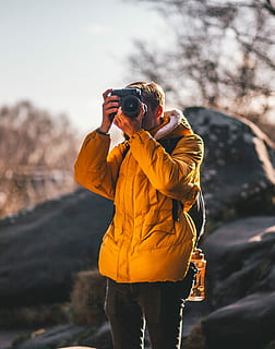 man, taking, picture, gray, rock, photo, using, dslr camera, mountain, pine, explorer, portrait, wood, leisure activity, real people, photography themes, one person, standing, technology, three quarter length, lifestyles, camera - photographic equipment, holding, focus on foreground, clothing, photographing, activity, casual clothing, nature, front view, day, men, outdoors, photographer, digital camera, obscured face, 2K, CC0, public domain, royalty free