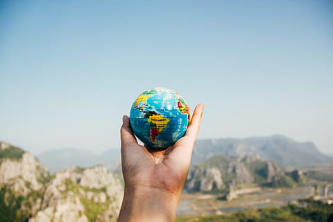 sky, hand, earth, traveling, adventure, ball-shaped, blur, close-up, focus, globe, mountain, outdoors, travel, travelling, world, human hand, human body part, environment, nature, globe - man made object, holding, day, one person, clear sky, blue, copy space, body part, sunlight, map, landscape, human limb, 5K, CC0, public domain, royalty free