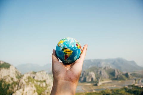 person holding globe, globe, global, map, round, colorful, outdoor, hand, palm, view, sky, mountain, highland, landscape, nature, human body part, human hand, one person, mid adult, holding, adults only, people, adult, outdoors, day, environment, globe - man made object, blue, clear sky, copy space, mountain range, body part, sunny, human limb, human arm, 5K